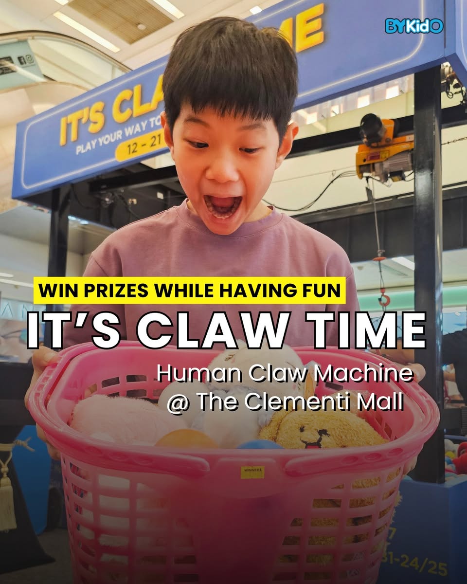 A child reaching for prizes in the Human Claw Machine