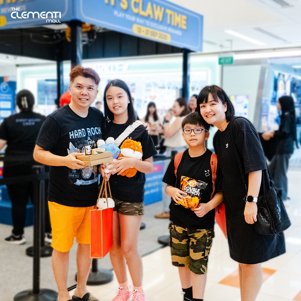 Excited participant reaching for prizes in the Human Claw Machine