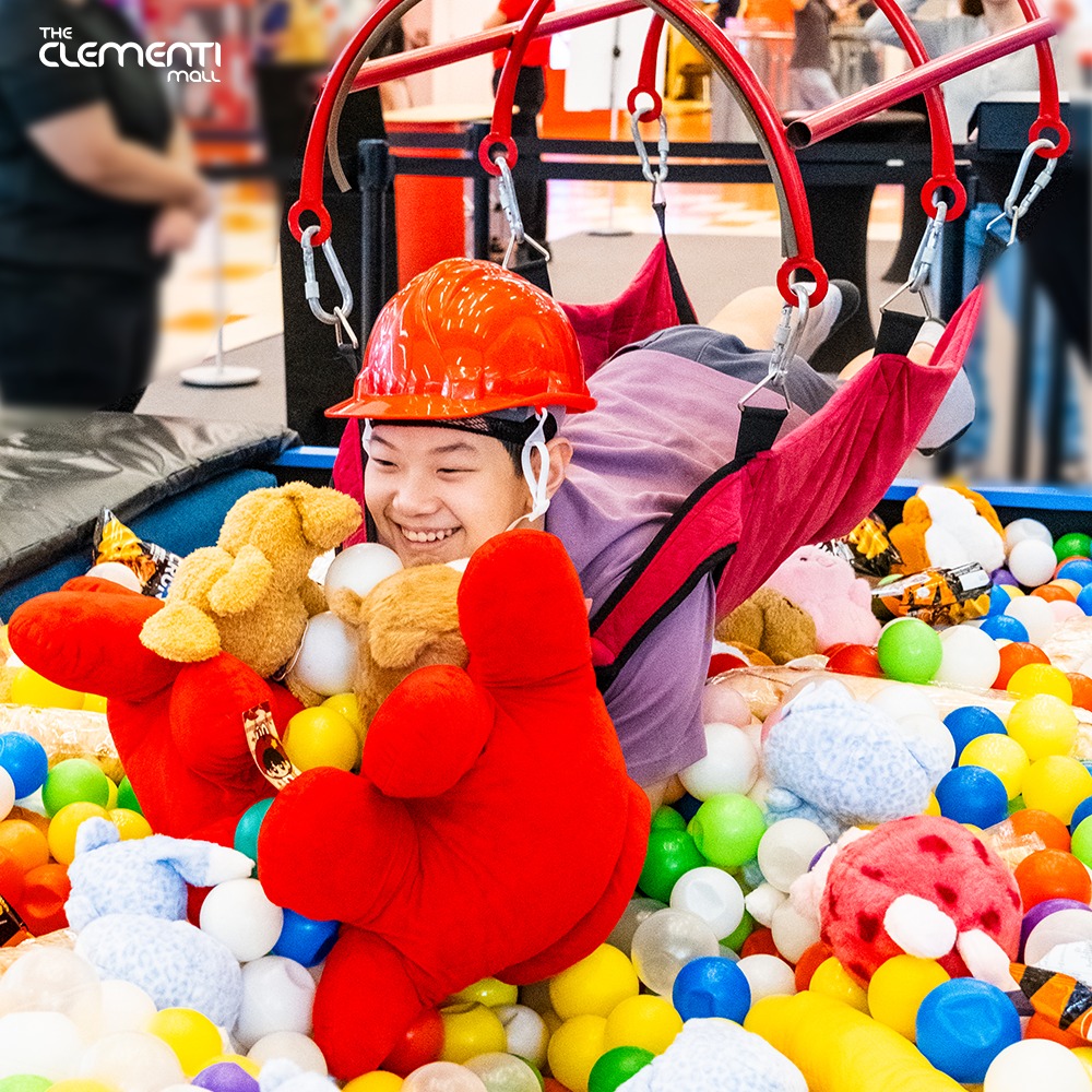 Happy customer showcasing their prize from the Human Claw Machine event