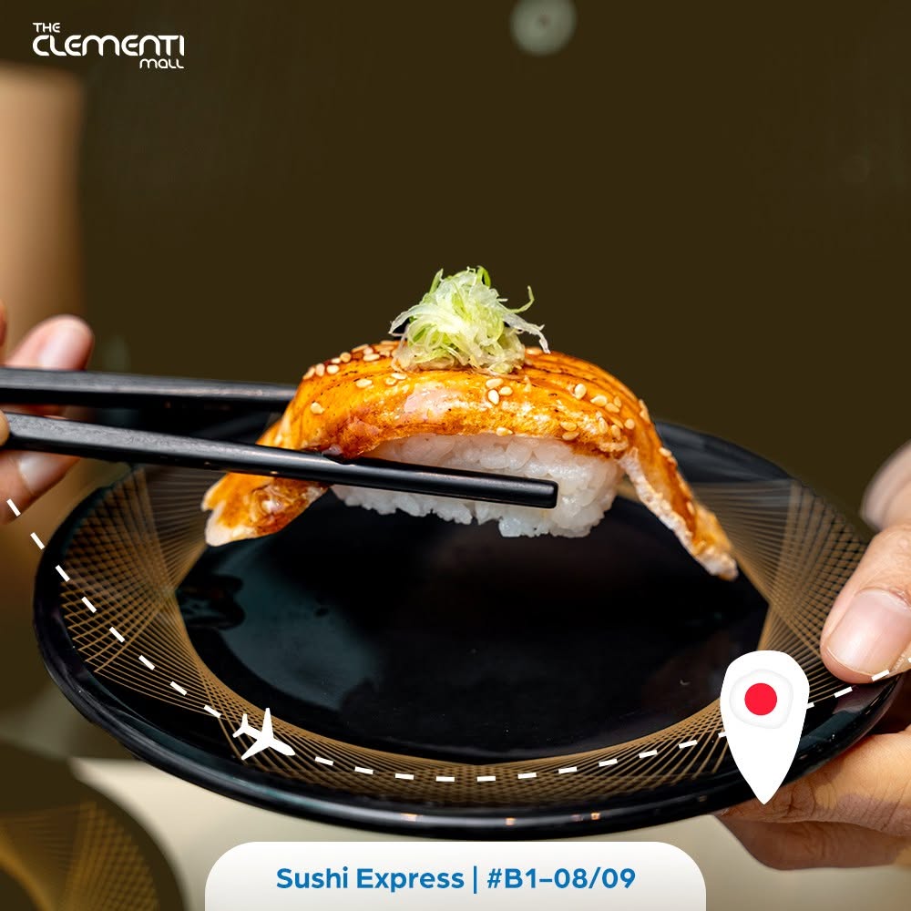 Sushi Express grilled salmon nigiri sushi on black plate with green onions and sesame seeds at Clementi Mall #B1-08/09